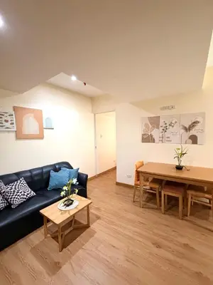 a living room with a couch and a table at SYM staycation at Azure in Manila