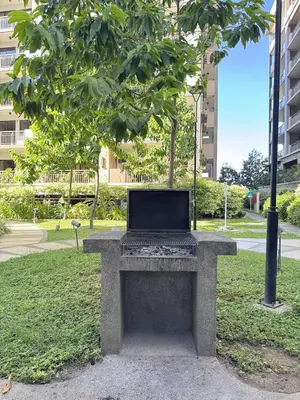 a laptop computer sitting on a bench in a park at Alea Residences 2 Bedroom Condo with Pool View Balcony in Manila