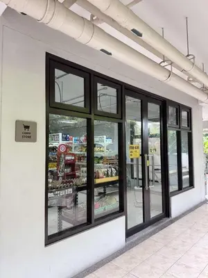 a store front with black windows in a store at Alea Residences 2 Bedroom Condo with Pool View Balcony in Manila
