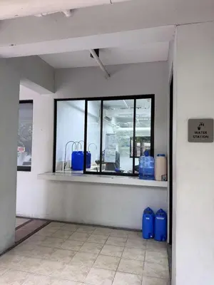 a room with a window and two blue containers at Alea Residences 2 Bedroom Condo with Pool View Balcony in Manila