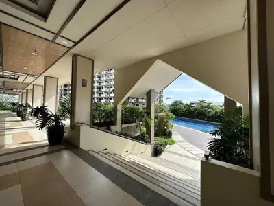 an empty lobby of a building with a swimming pool at Alea Residences 2 Bedroom Condo with Pool View Balcony in Manila