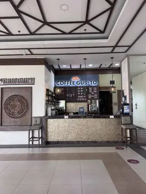 a coffee shop with a bar in a building at Alea Residences 2 Bedroom Condo with Pool View Balcony in Manila