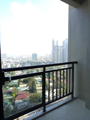 a balcony with a view of a city at Grand Soho Makati in Manila