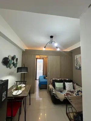 a living room with a couch and a table at Shore 2 Residences, Tower 1 in Manila