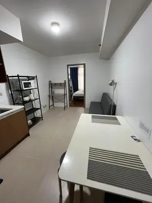 a living room with a white table and a couch at Antel Spa Residences 1708 in Manila