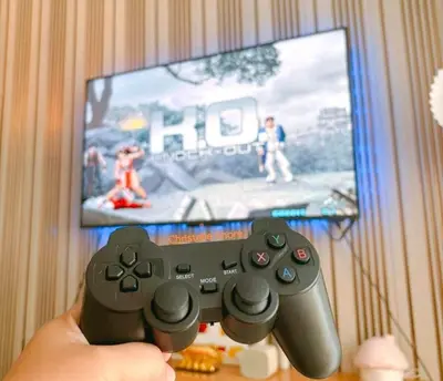 a person holding a video game controller in front of a tv at 1BR Near MOA Balcony & Wi-Fi in Manila