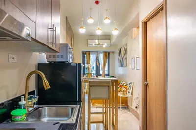 a kitchen with a sink and a counter top at 1BR Near MOA Balcony & Wi-Fi in Manila