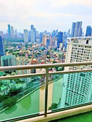 a view of a city with a river and buildings at 1BR with balcony near Makati in Manila