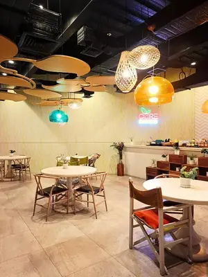 a restaurant with tables and chairs and lights at 1BR with balcony near Makati in Manila