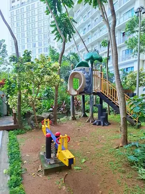 a playground in a park with a monkey on a slide at 1BR with balcony near Makati in Manila
