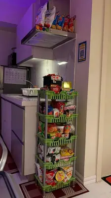 a kitchen with an open refrigerator filled with food at The Bawhaus in Manila