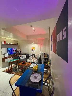 a living room with a blue table and a couch at The Bawhaus in Manila