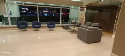 a lobby with couches and chairs in a building at Sea Residences Joy in Manila