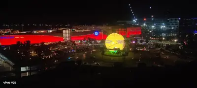 a city lit up at night with a large crowd of people at Sea Residences Joy in Manila
