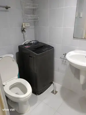 a bathroom with a toilet and a sink at Sea Residences Joy in Manila