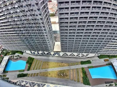 an overhead view of two tall buildings with two pools at Blush & Glam at SMDC Fame Residences Tower 3 in Manila