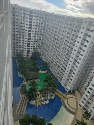 an aerial view of a large building with a pool at Shore Residences Mall Of Asia Cj in Manila