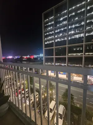 a view of a building from a balcony at night at Shore Residences Mall Of Asia Cj in Manila