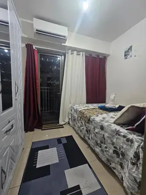 a small bedroom with a bed and a window at Shore Residences Mall Of Asia Cj in Manila