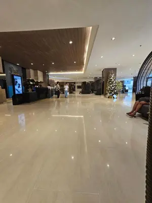an empty lobby with a christmas tree on the floor at Shore Residences Mall Of Asia Cj in Manila