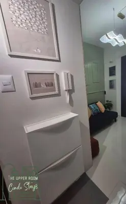 a white refrigerator in a room with a couch at 1128 Positano in Manila