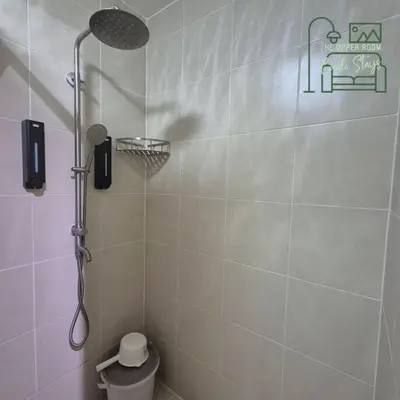 a shower with a shower head in a bathroom at 1128 Positano in Manila