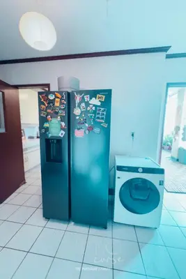 two refrigerators in a room with a washing machine at Hidden Gem - Spacious Penthouse with Siargao Vibe in Manila