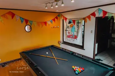 a pool table in the corner of a room at Hidden Gem - Spacious Penthouse with Siargao Vibe in Manila