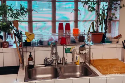 a kitchen sink with plants and a window at Hidden Gem - Spacious Penthouse with Siargao Vibe in Manila