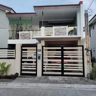 a house with two gates in front of it at Cozy Private Retreat with Kitchen & Balcony in Bacoor
