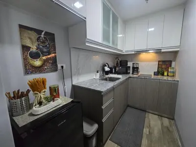a small kitchen with white cabinets and a sink at Gentry Manor Okada Westside City Paranaque by Royale Prestige Le Maison in Manila