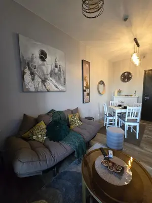 a living room with a couch and a table at Gentry Manor Okada Westside City Paranaque by Royale Prestige Le Maison in Manila
