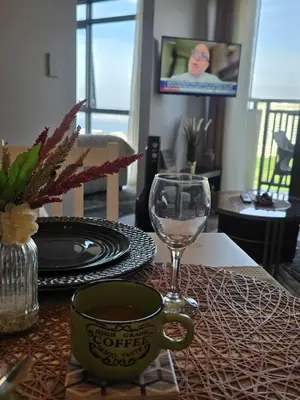 a table with a plate and a glass of wine at Gentry Manor Okada Westside City Paranaque by Royale Prestige Le Maison in Manila