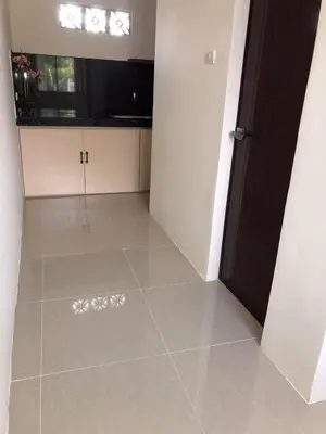 an empty room with a door and a tile floor at Wilabdaman manila in Manila