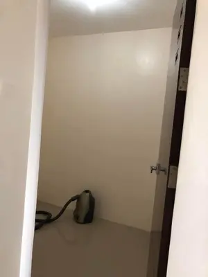a room with a white wall and a door at Wilabdaman manila in Manila