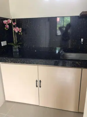 a kitchen with a sink and a counter top at Wilabdaman manila in Manila