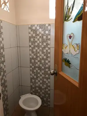 a bathroom with a toilet and a door at Wilabdaman manila in Manila
