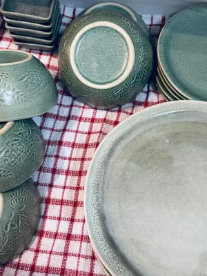 a group of plates sitting on top of a table at Pahinga Luxury Stays in Manila