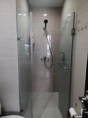 a bathroom with a shower with a glass door at Cluster 1 9N in Manila