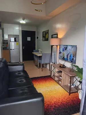 a living room with a couch and a table at Cluster 1 9N in Manila