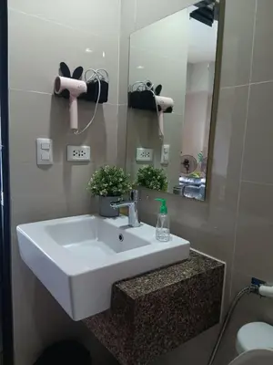 a bathroom with a white sink and a mirror at Cluster 1 9N in Manila