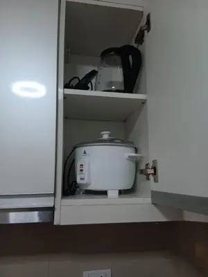 a kitchen cabinet with a white appliance in it at Cluster 1 9N in Manila