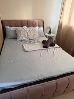 a bed with a pair of shoes sitting on it at Nordic Style 1br Shore 2 Residences Tower 3 in Manila