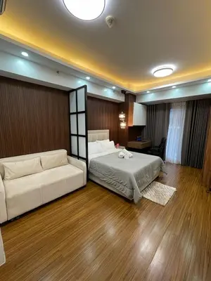 a large bedroom with a bed and a couch at 81 Newport Building across NAIA Terminal 3 C5-8C in Manila