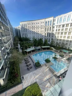 an overhead view of a large building with a swimming pool at 81 Newport Building across NAIA Terminal 3 C5-8C in Manila