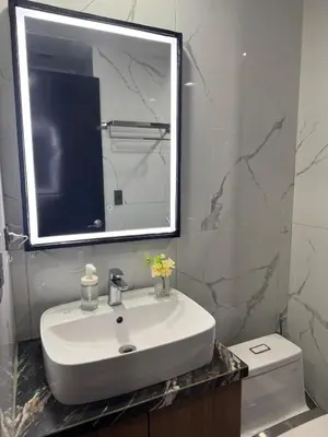 a bathroom with a sink and a mirror and a toilet at 81 Newport Building across NAIA Terminal 3 C5-8C in Manila
