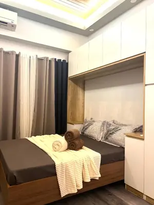 a bedroom with a bed with towels on it at Shore Residences Direct Pool Access in Manila