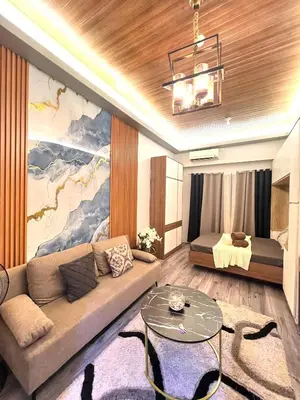 a living room with a couch and a bed at Shore Residences Direct Pool Access in Manila