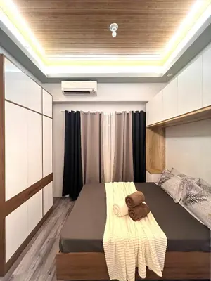 a bedroom with a large bed in a room at Shore Residences Direct Pool Access in Manila