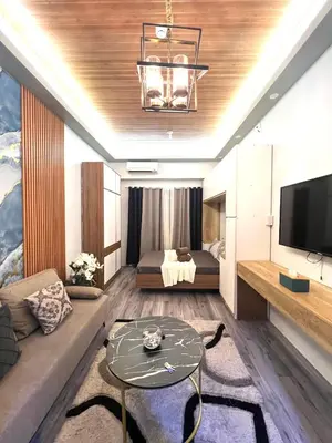 a living room with a couch and a tv at Shore Residences Direct Pool Access in Manila